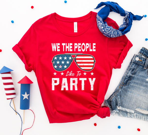 Bye Felicia Goods® “We The People Like to Party” Red, White & Blue T-Shirt – Patriotic Graphic Tee