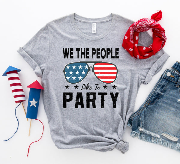 Bye Felicia Goods® “We The People Like to Party” Red, White & Blue T-Shirt – Patriotic Graphic Tee