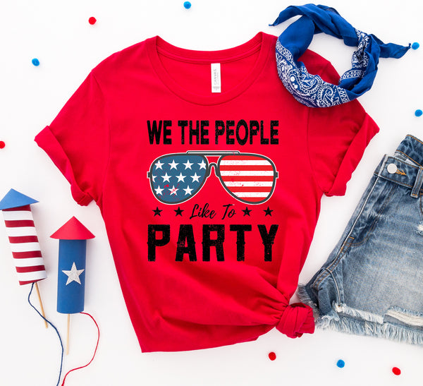 Bye Felicia Goods® “We The People Like to Party” Red, White & Blue T-Shirt – Patriotic Graphic Tee