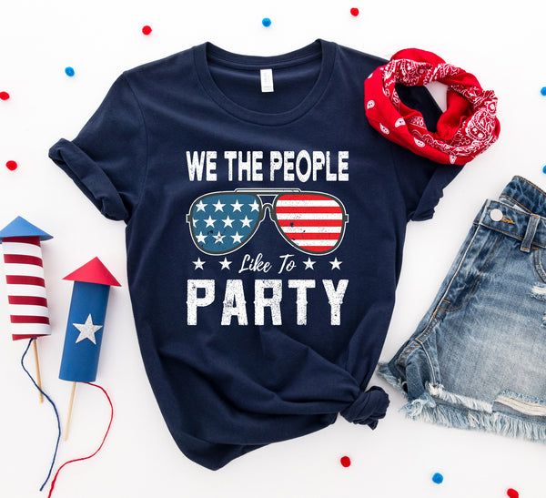 Bye Felicia Goods® “We The People Like to Party” Red, White & Blue T-Shirt – Patriotic Graphic Tee